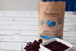 finnberry, blueberry pack sitting on white brick surface, next to a dish of the contents