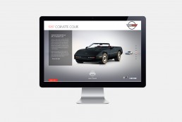 Desktop monitor showcasing a 1987 Black Vintage Chevrolet Corvette Coupe