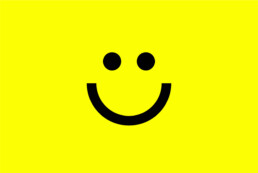 Happy Marketer smiley face icon in black on a yellow background created by branding agency DBC Creative Agency
